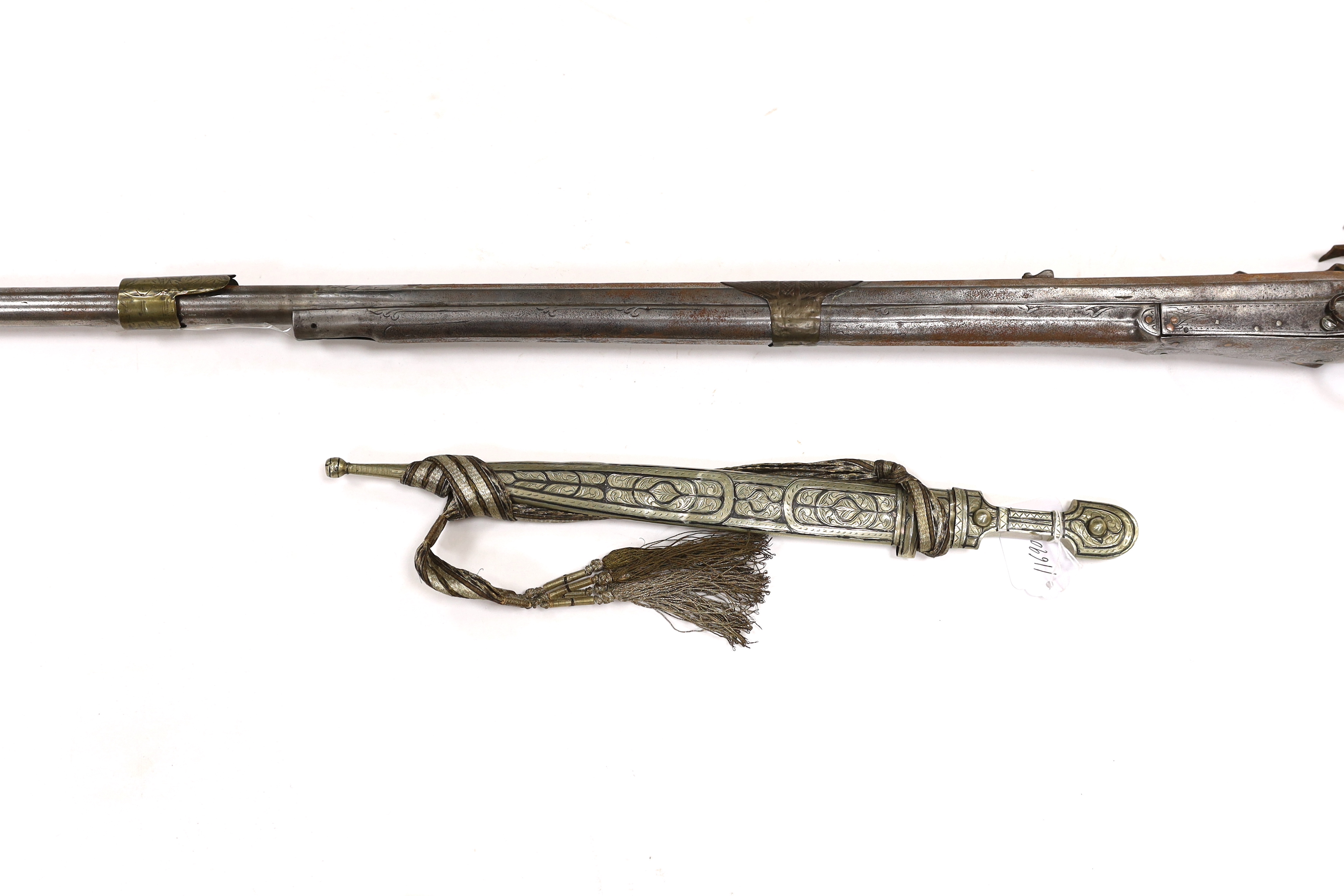 A 19th century Albanian flintlock miquelet lock rifle (Balkan long arm) and a Caucasian style dagger, with niello work scabbard, barrel 122cm (2)
